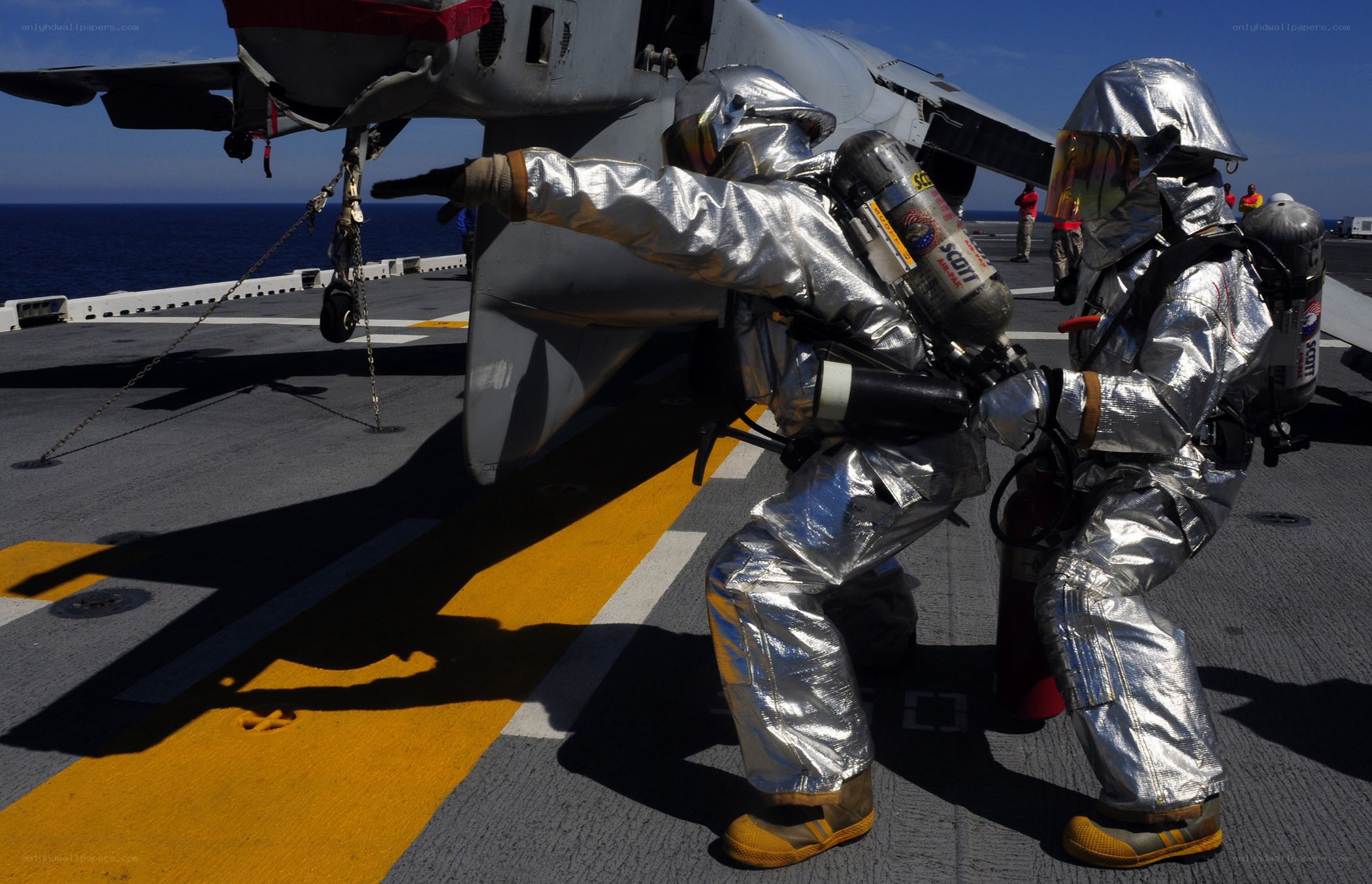 Firefighters on aircraft carrier deck