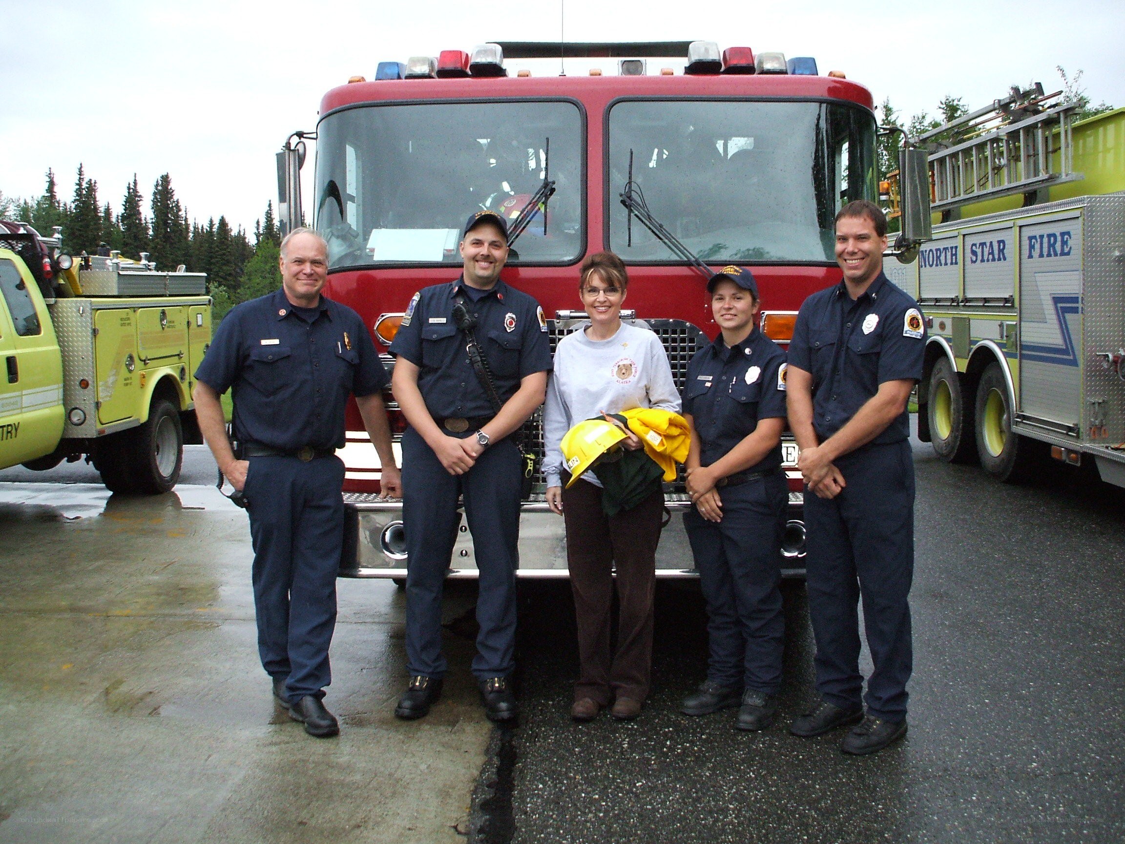 Firefighters posing with fire truck
