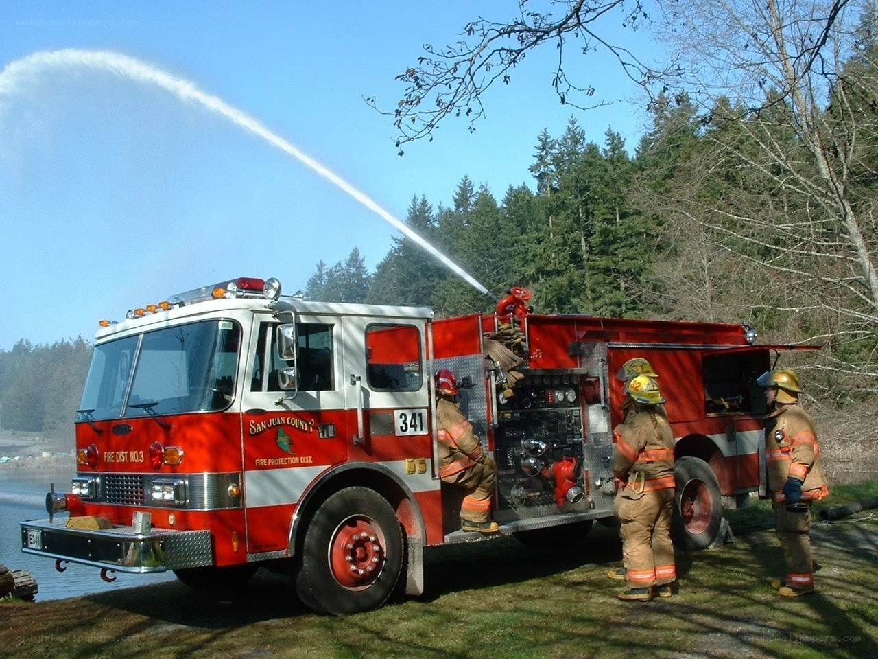 Firefighters using a fire truck