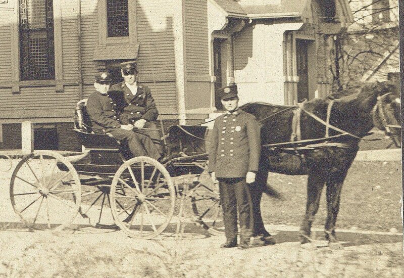 Firefighters with horse-drawn carriage