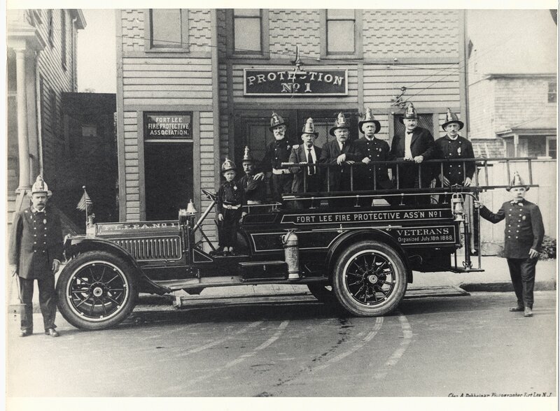 Firefighters with vintage fire truck