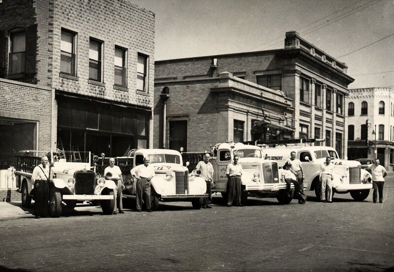 Firefighters with vintage trucks