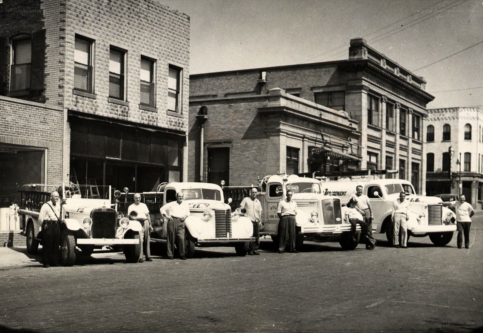 Firefighters with vintage trucks