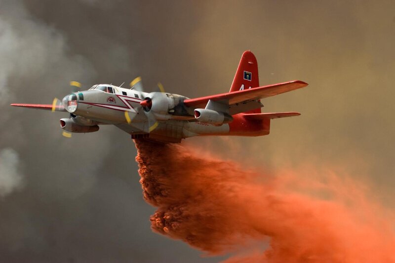 Firefighting aircraft dropping retardant