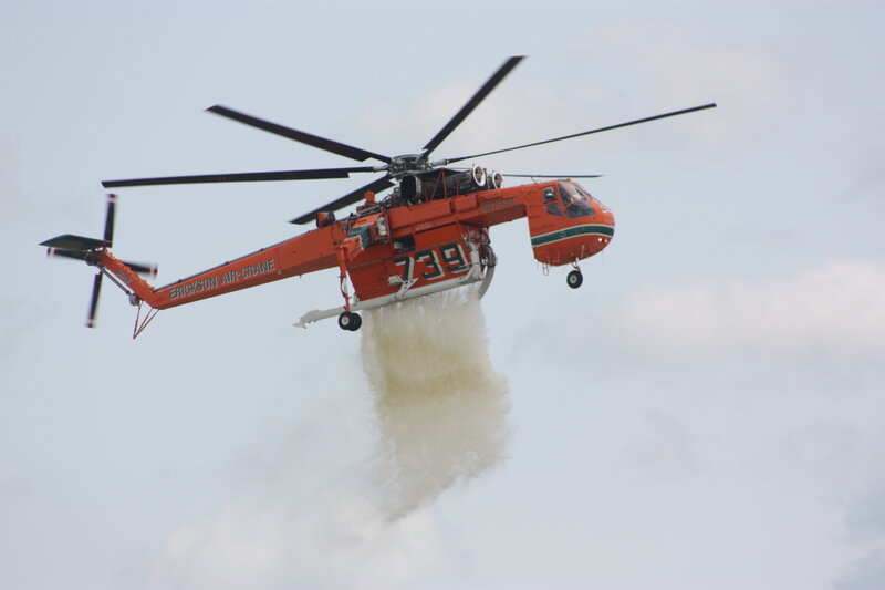Firefighting helicopter dropping water