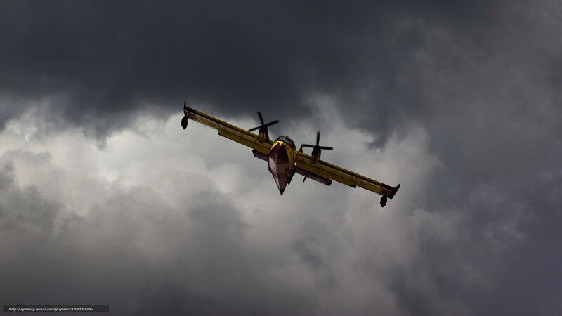 Firefighting plane in stormy sky