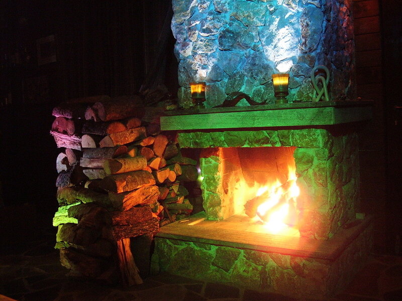 fireplace with logs and candles