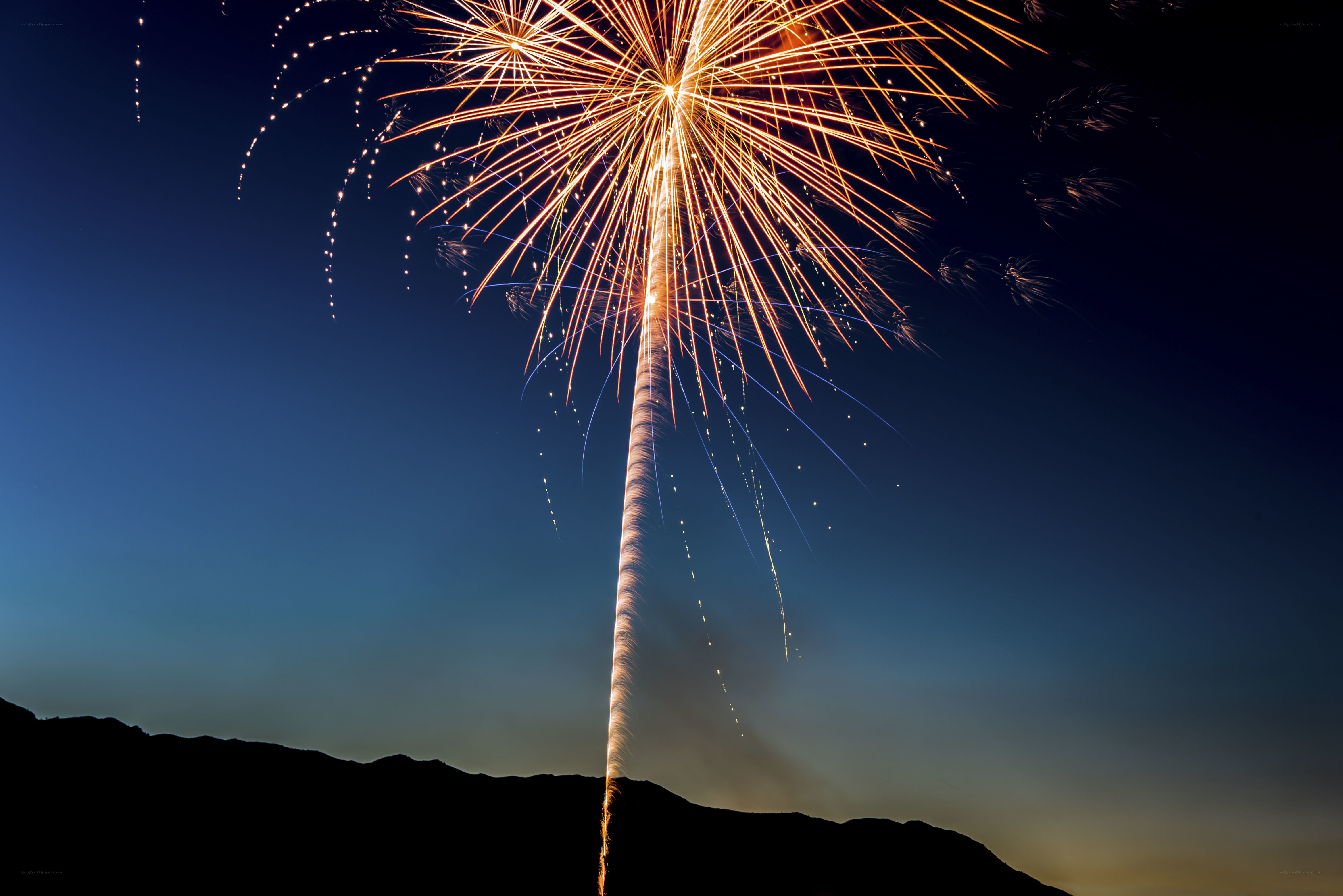 Fireworks display over mountains