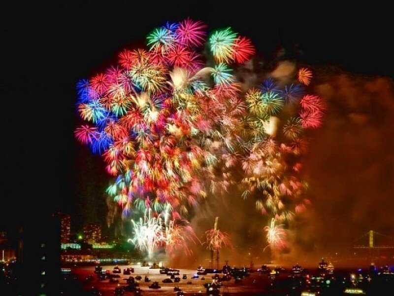 Fireworks Display over Water — Red, Festive, Night, Photograph, City Skyline