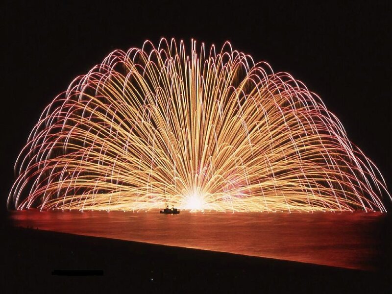 Fireworks Display over Water — Yellow