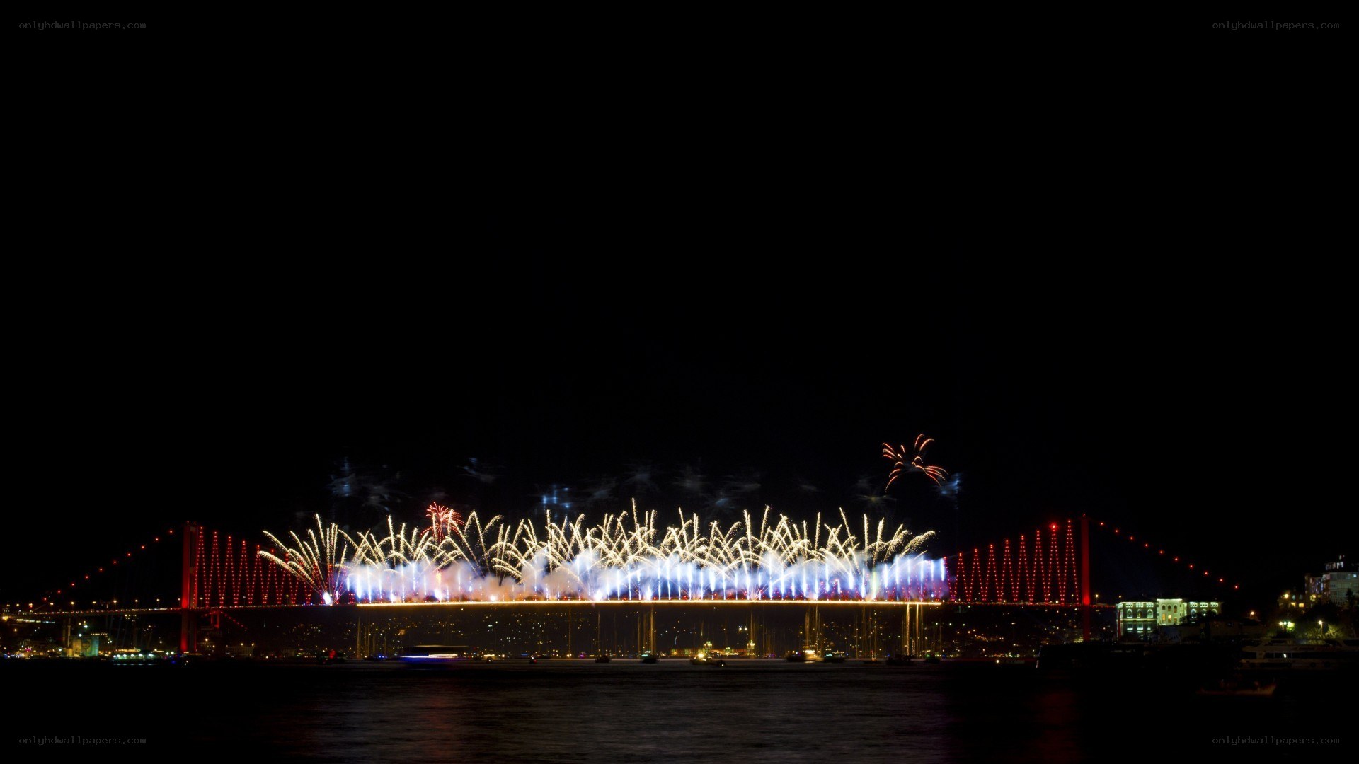 Fireworks over a bridge at night