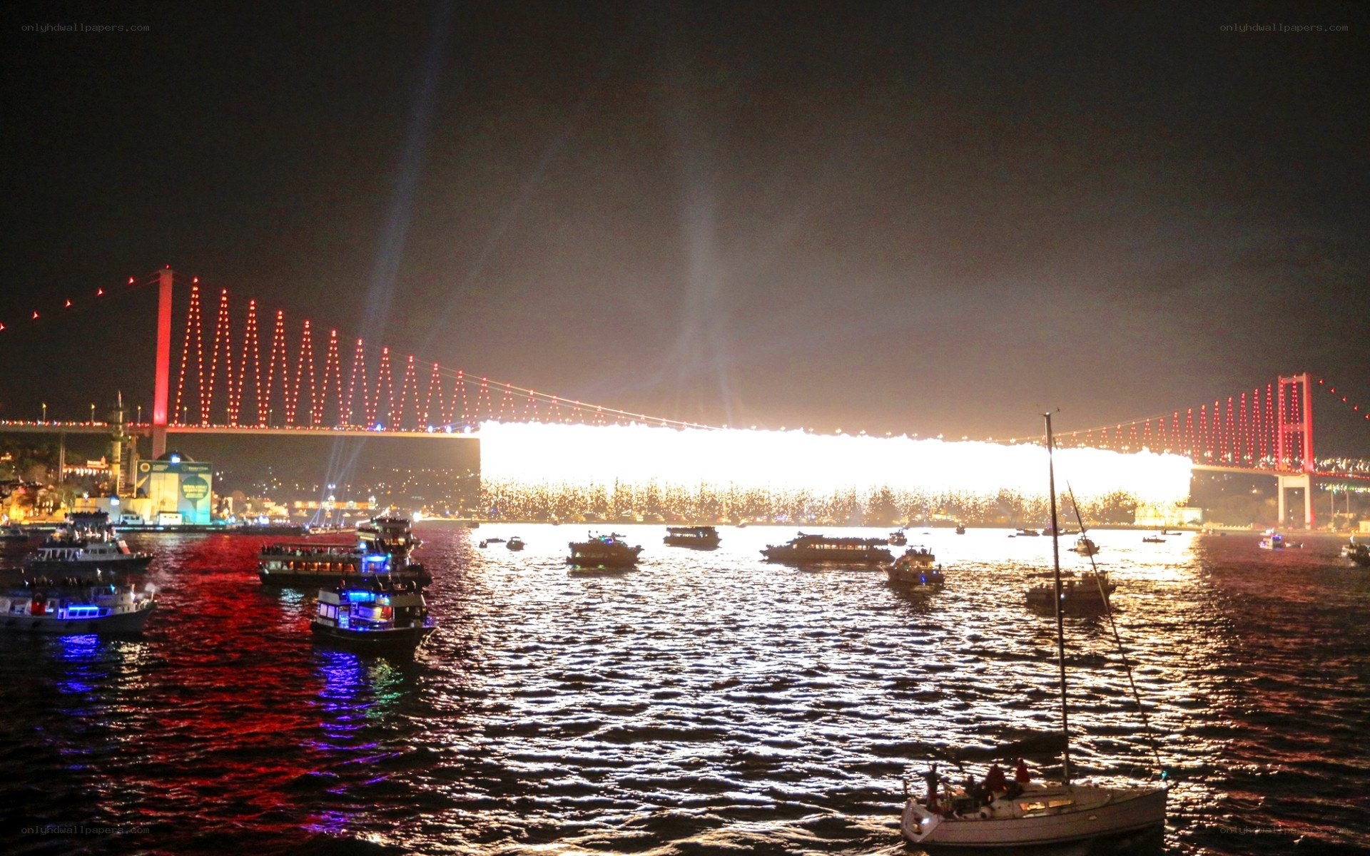 Fireworks over a bridge at night