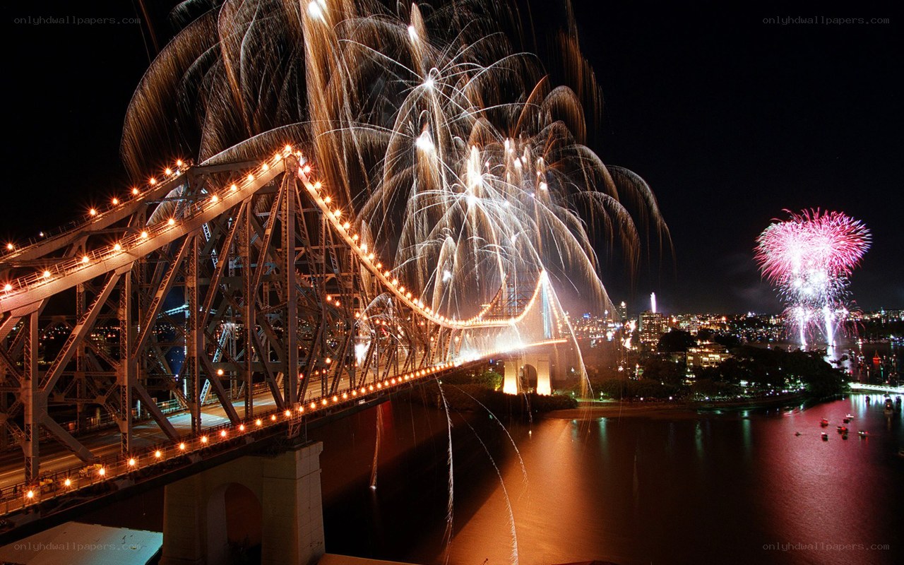 Fireworks over a bridge at night