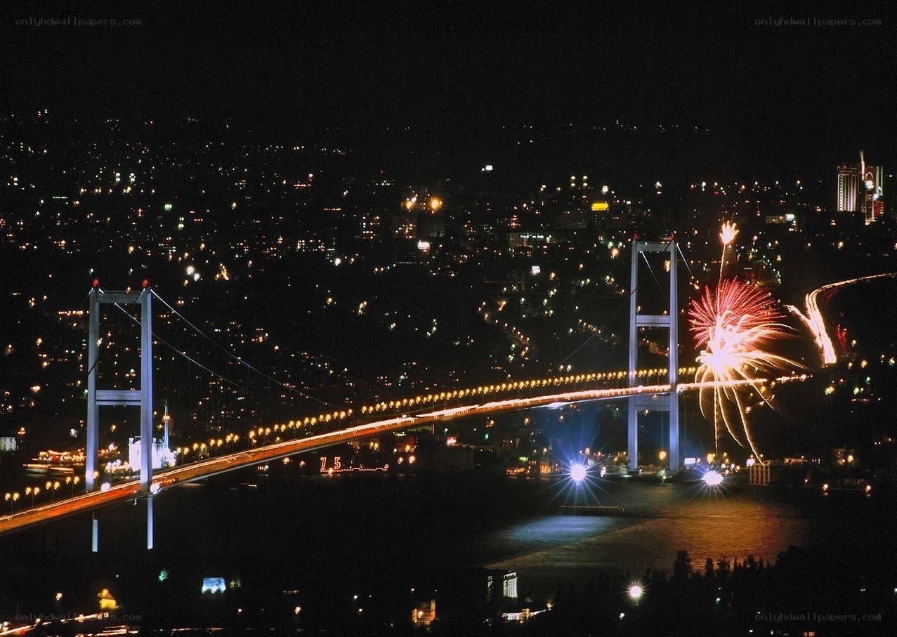 Fireworks over a bridge at night