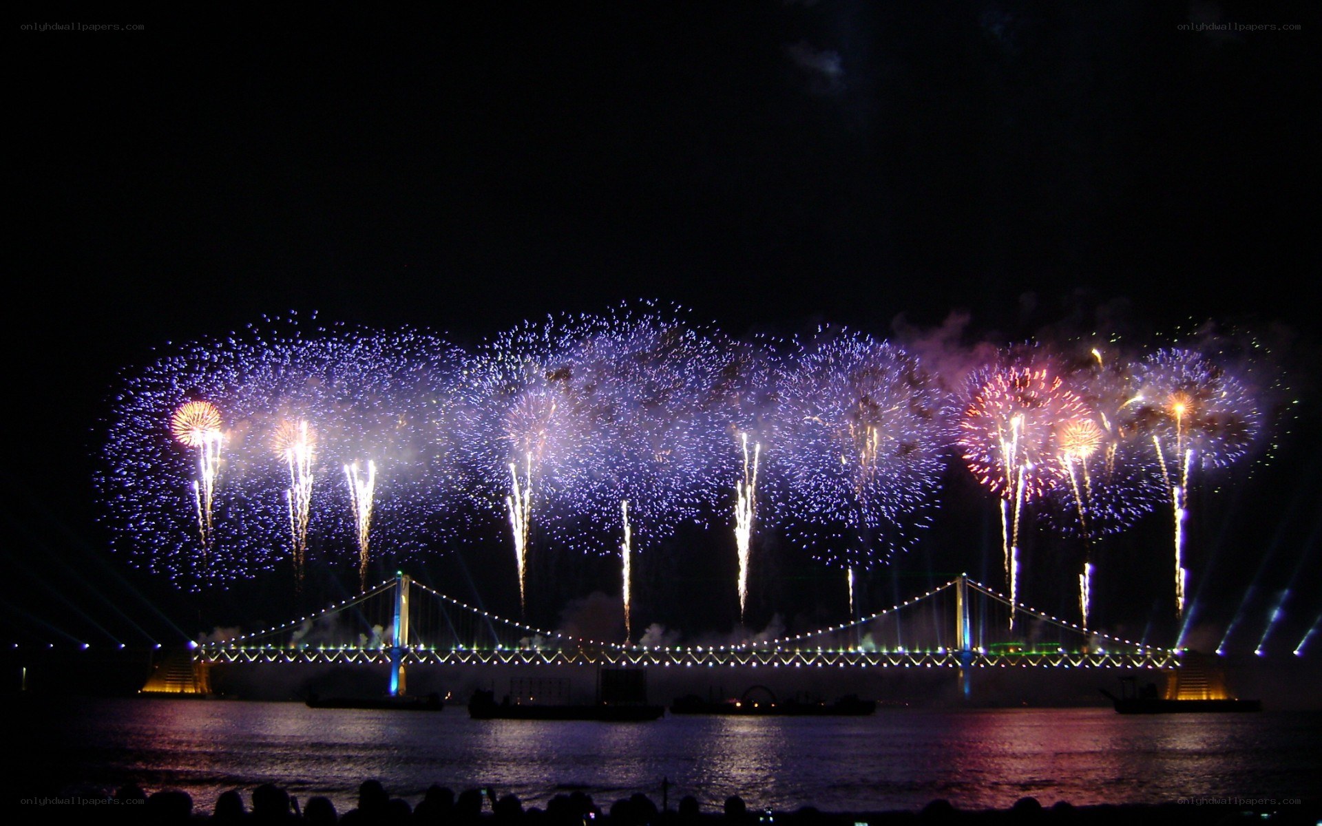 Fireworks over a bridge at night