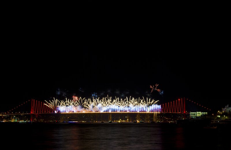 Fireworks over a bridge at night