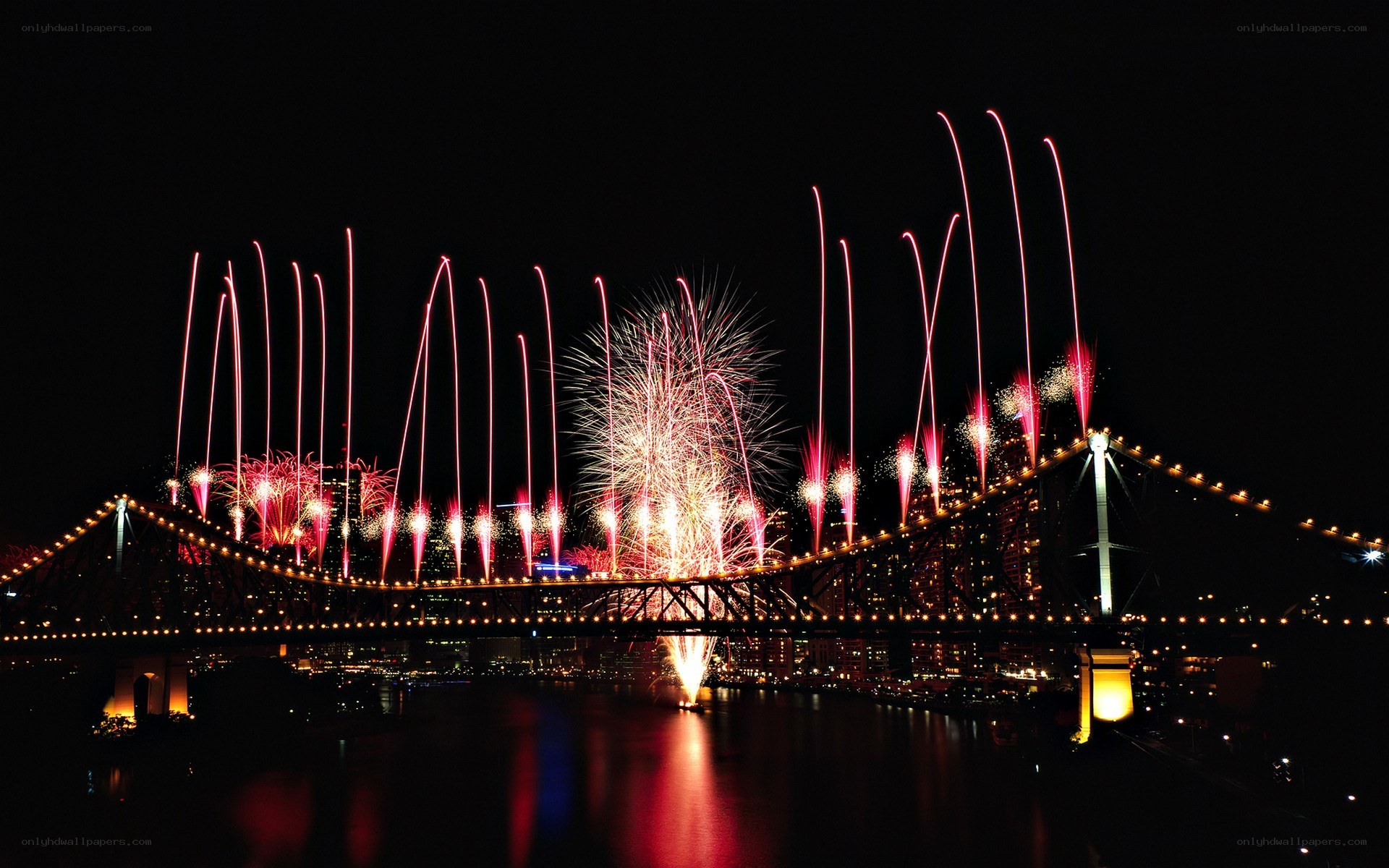 Fireworks over a bridge at night