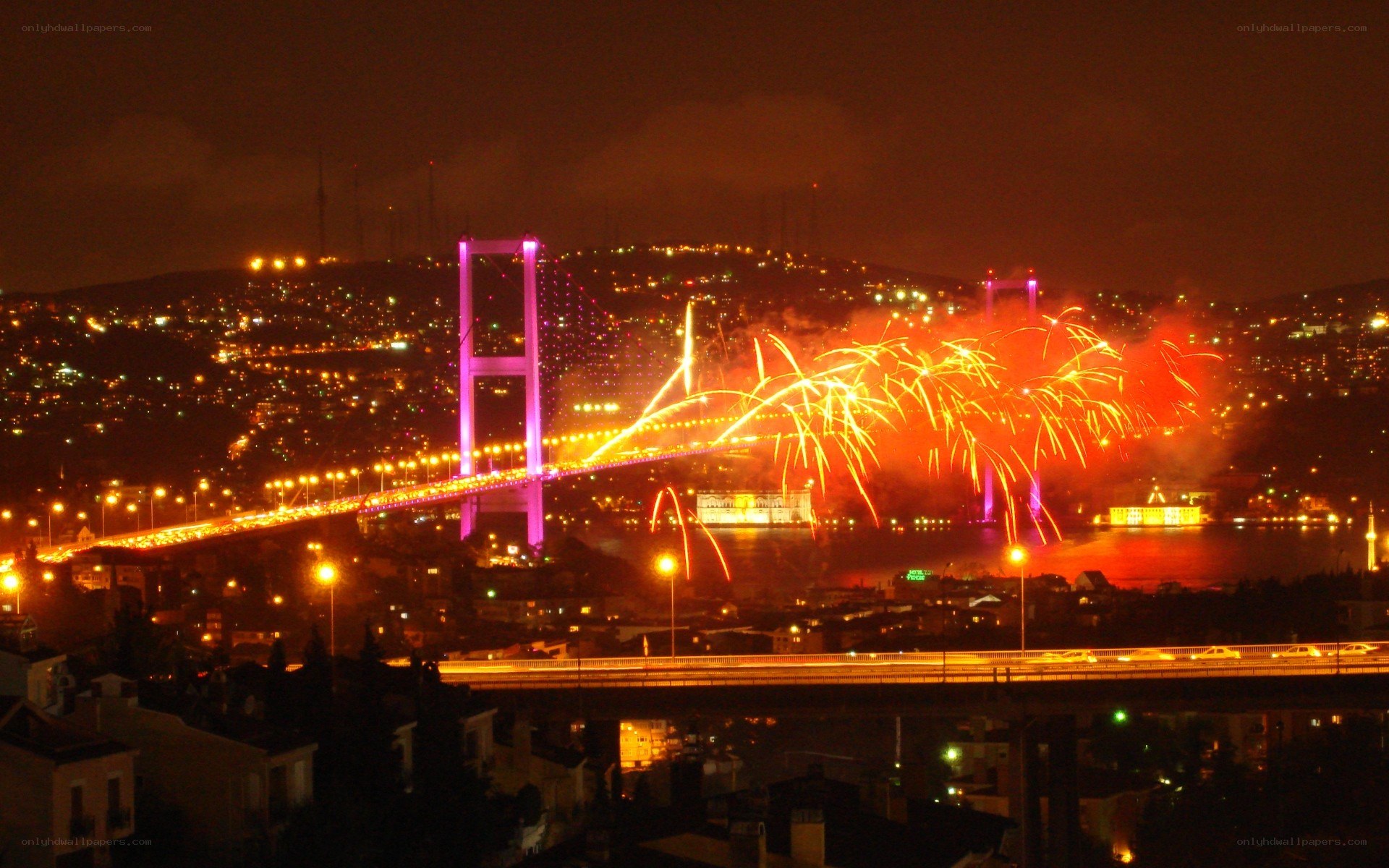 Fireworks over a bridge at night