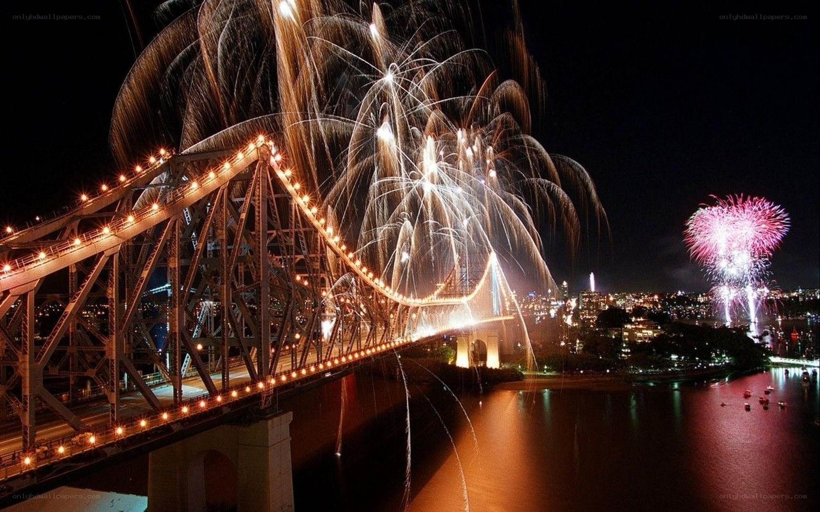 Fireworks over a bridge at night