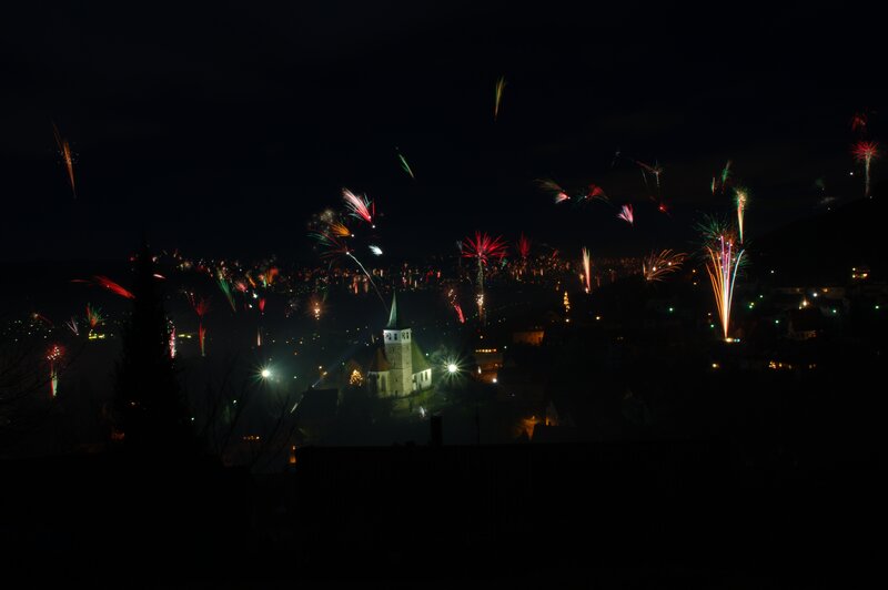 Fireworks over a church at night