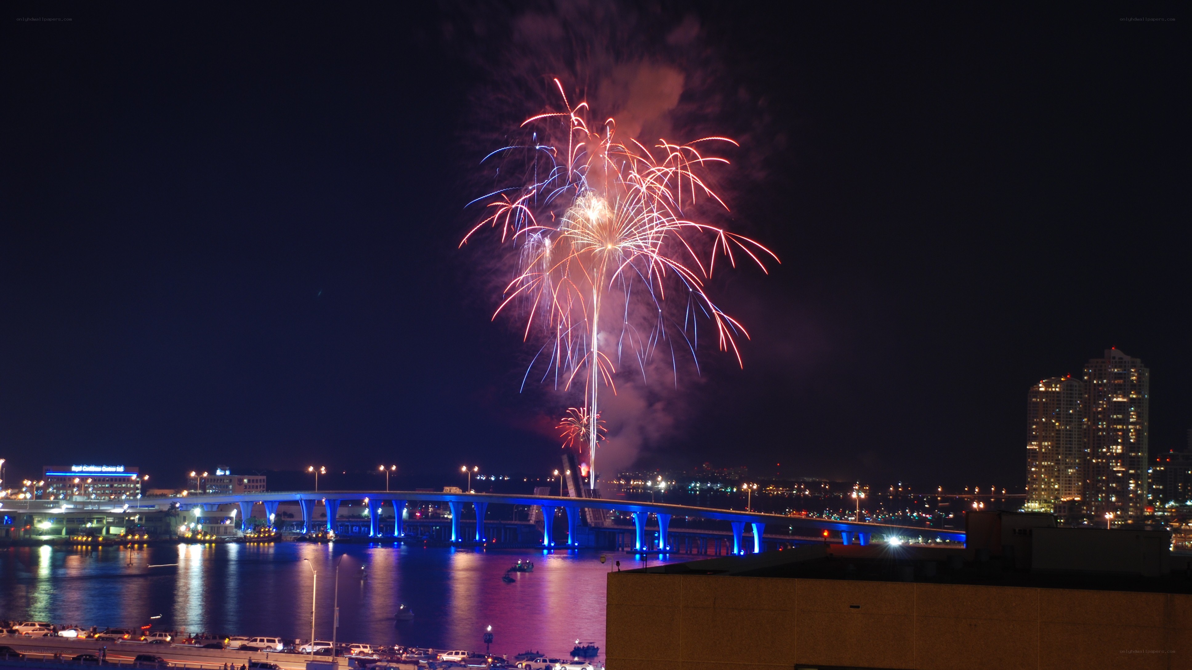 Fireworks over a city bridge