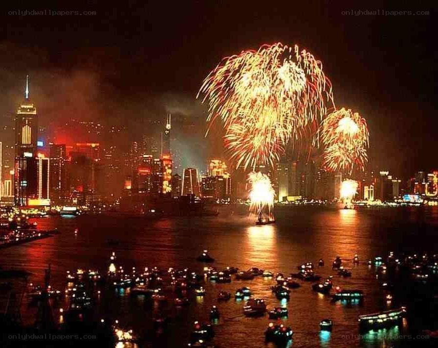 Fireworks over a city harbor