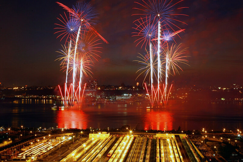 Fireworks over a city harbor