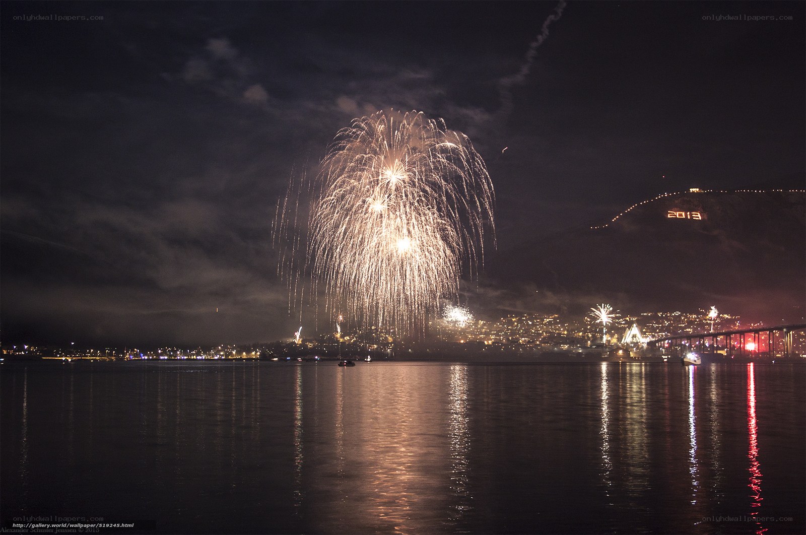 Fireworks over a city harbor