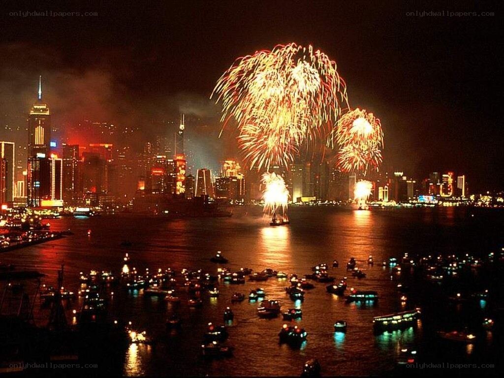 Fireworks over a city harbor