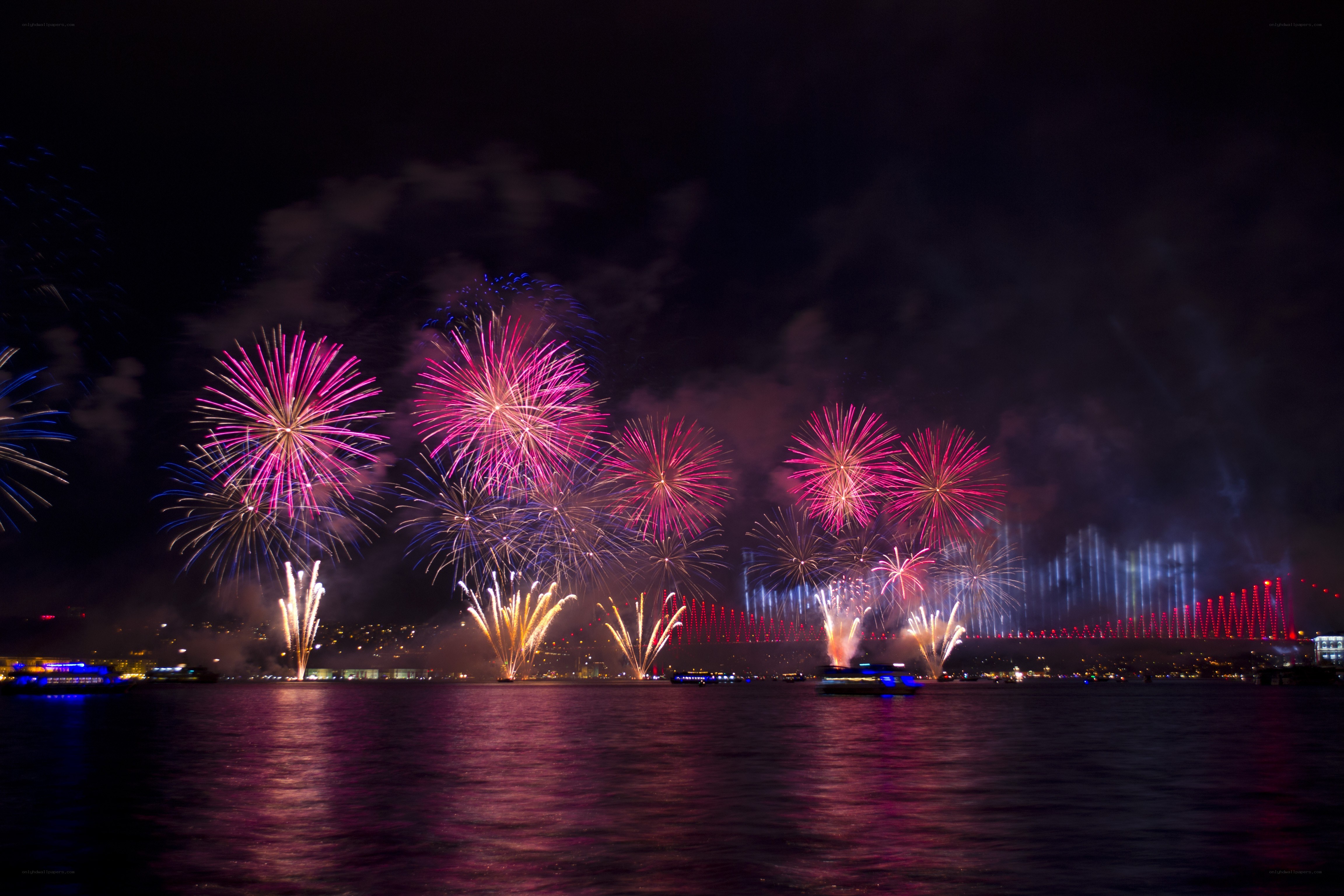 Fireworks over a city harbor