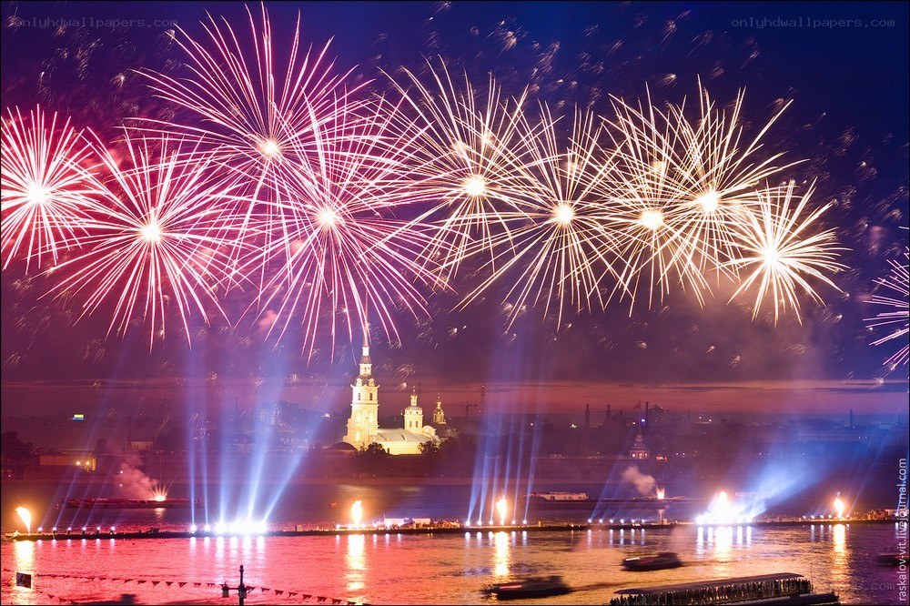 Fireworks over a city river