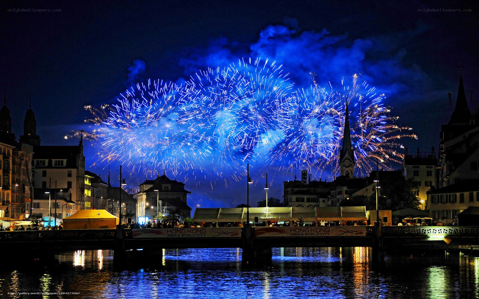 Fireworks over a city river