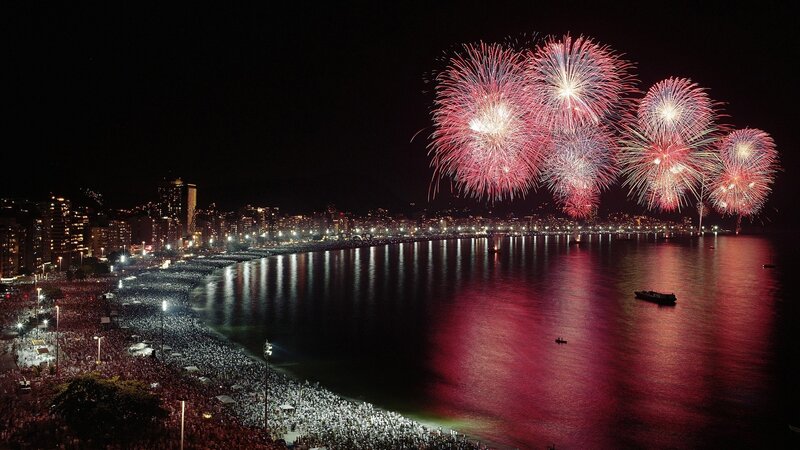 Fireworks over a crowded beach