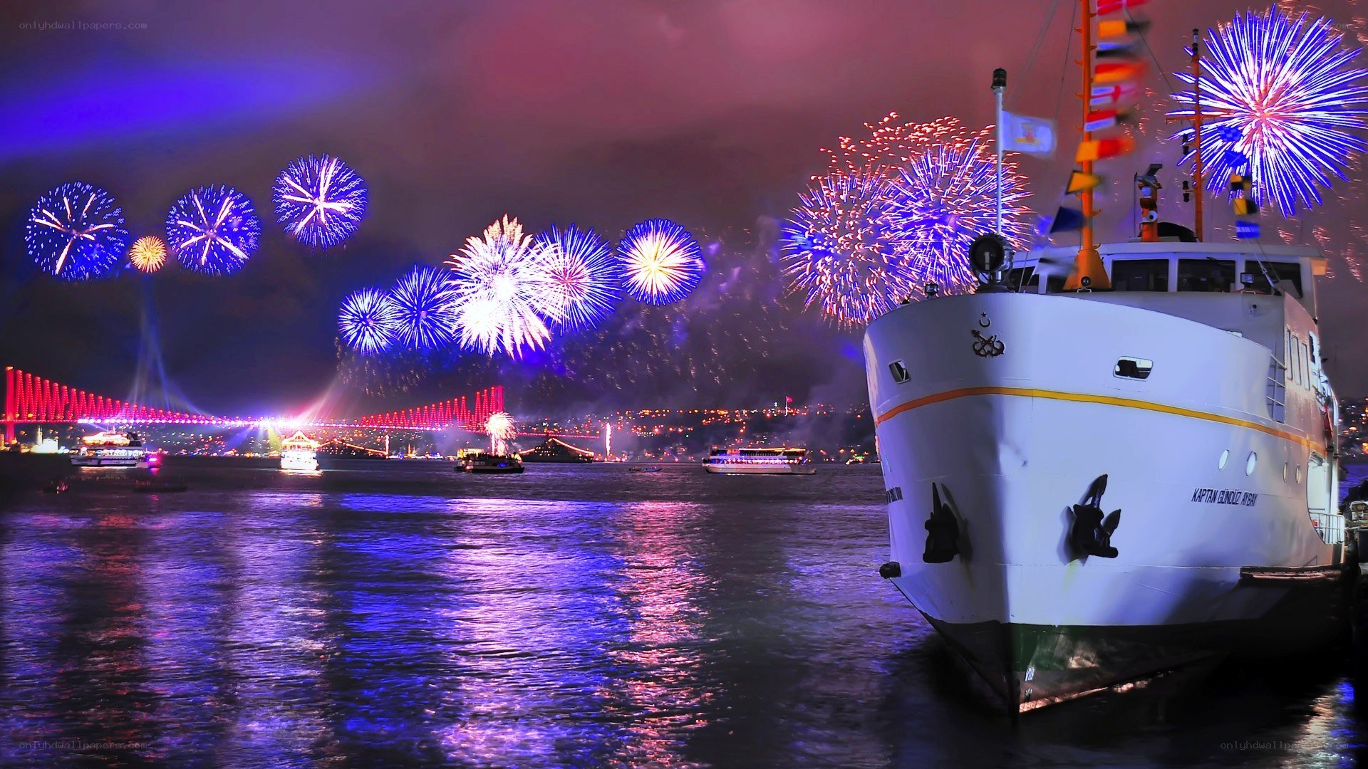 Fireworks over a harbor at night