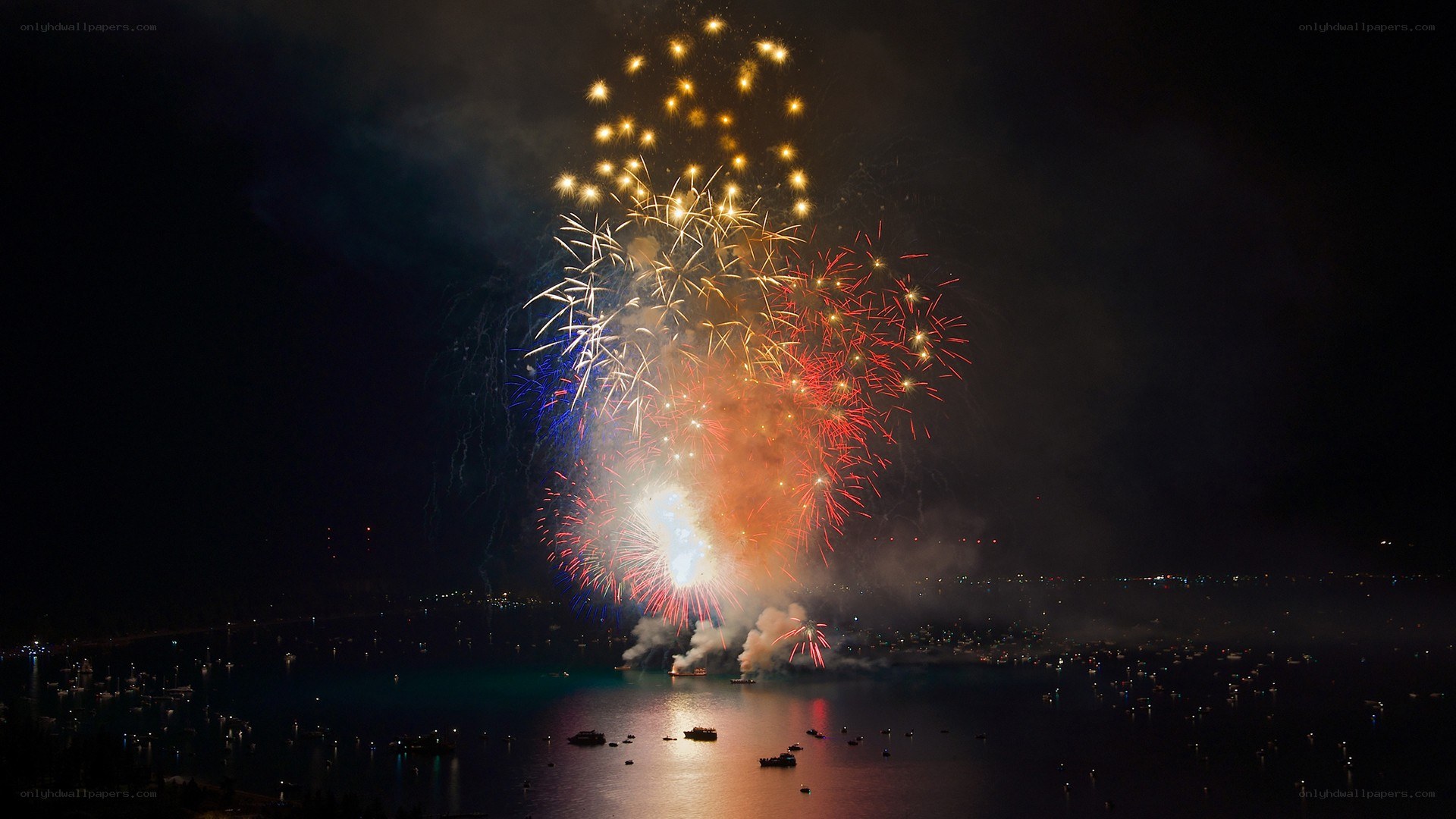 Fireworks over a harbor at night