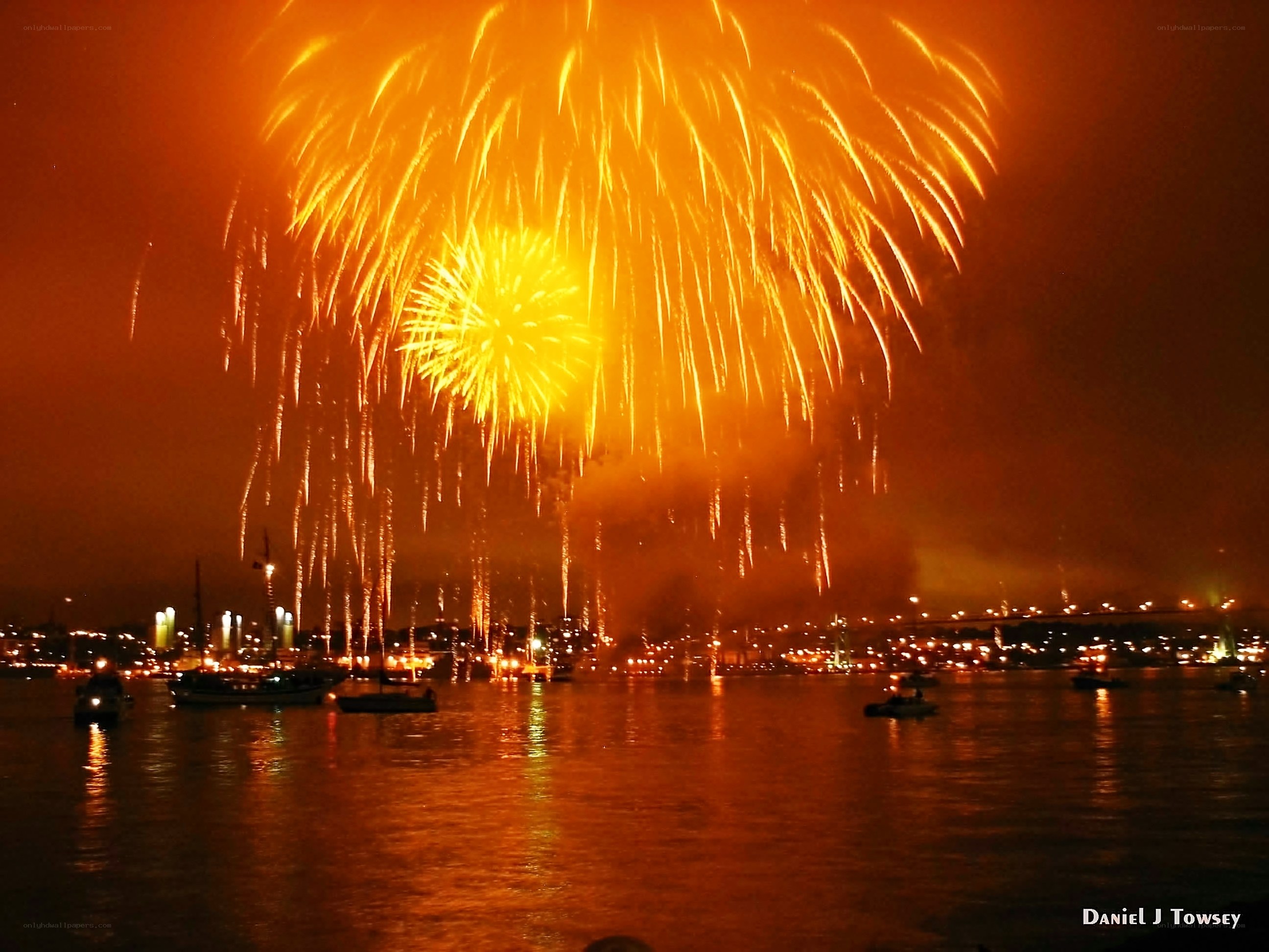 Fireworks over a harbor at night