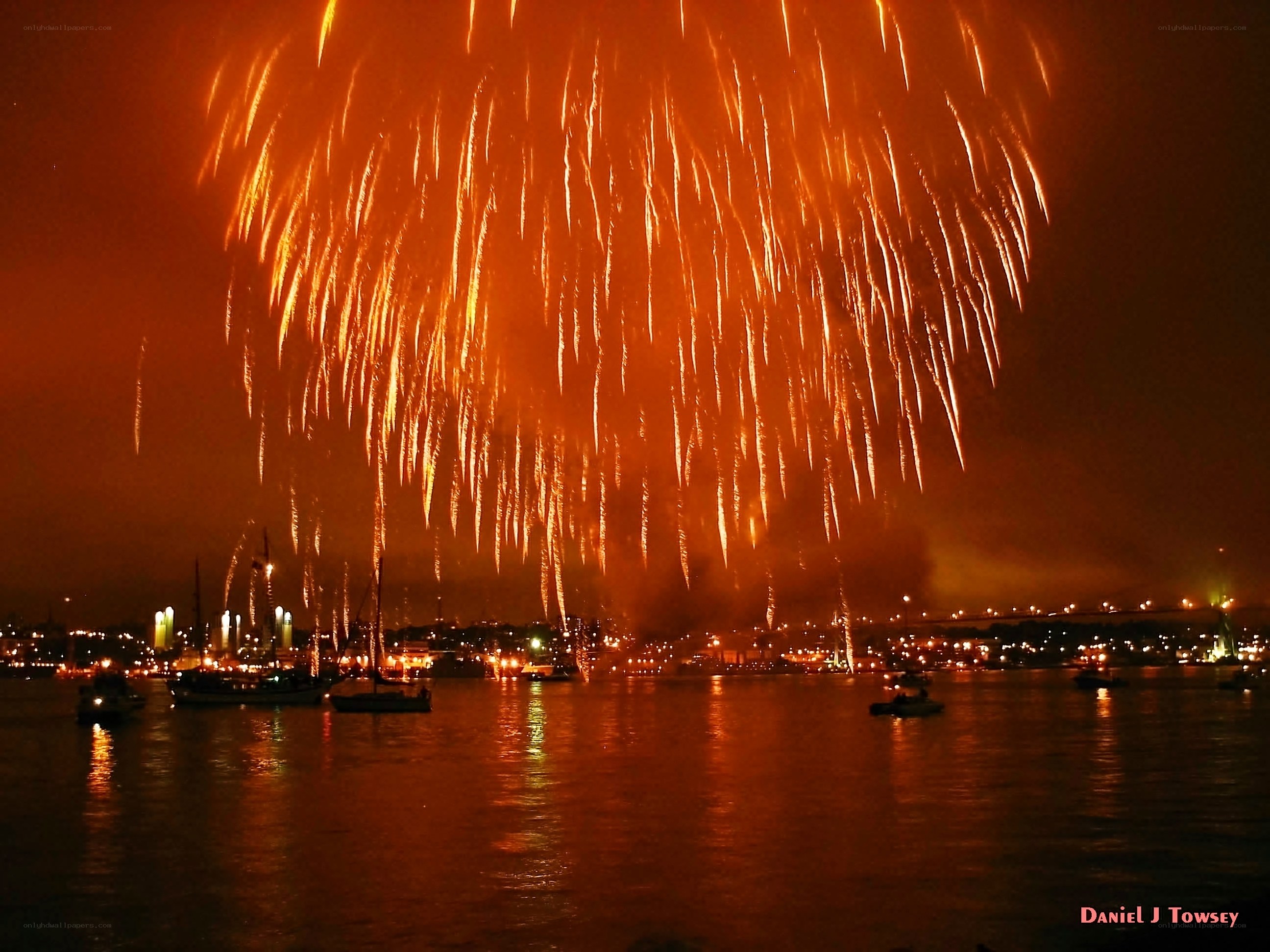 Fireworks over a harbor at night