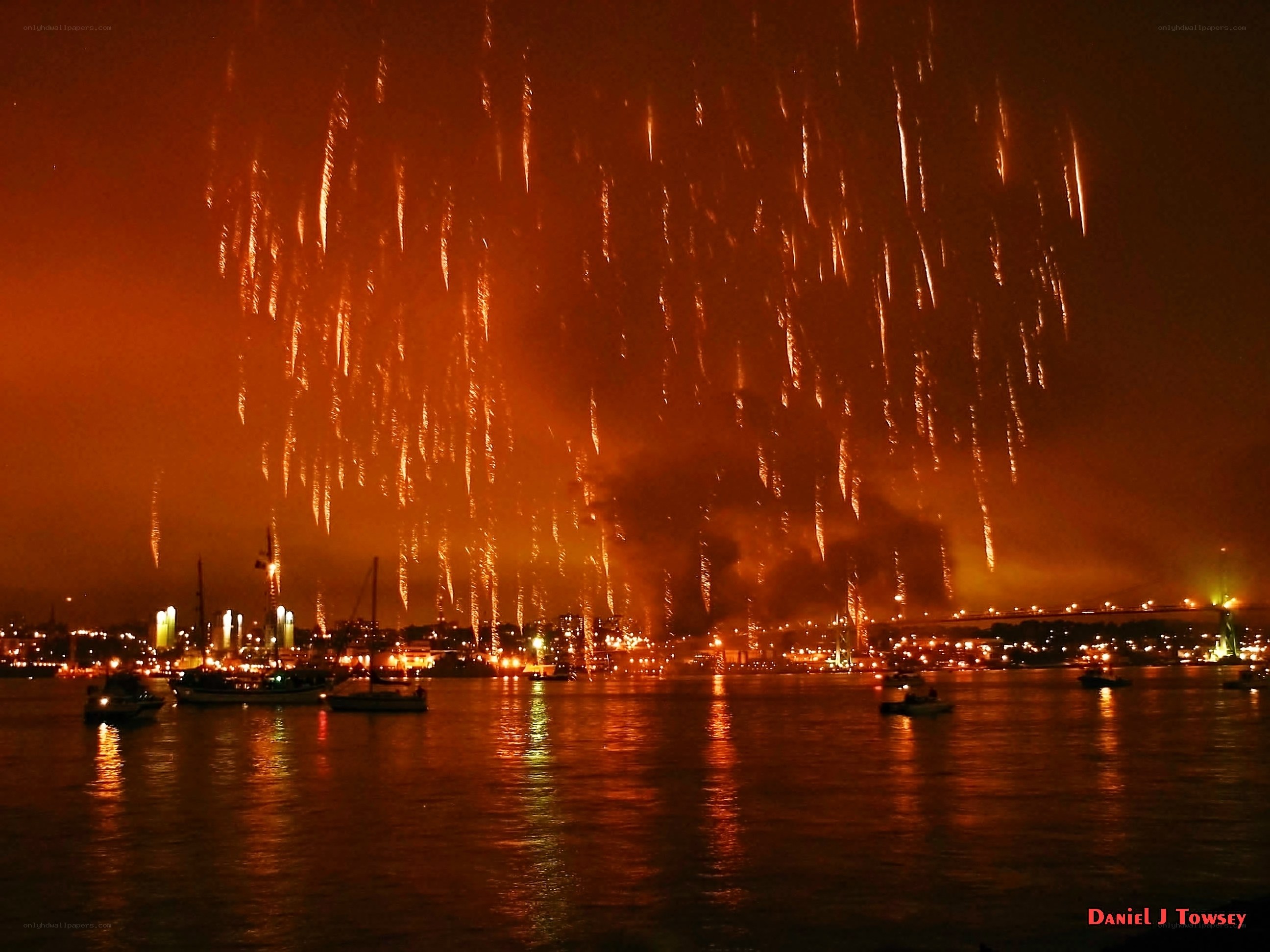 Fireworks over a harbor at night