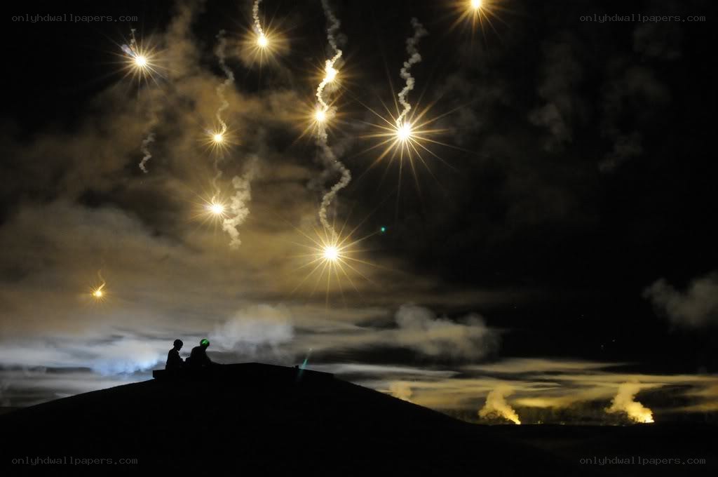 Fireworks over a hill at night