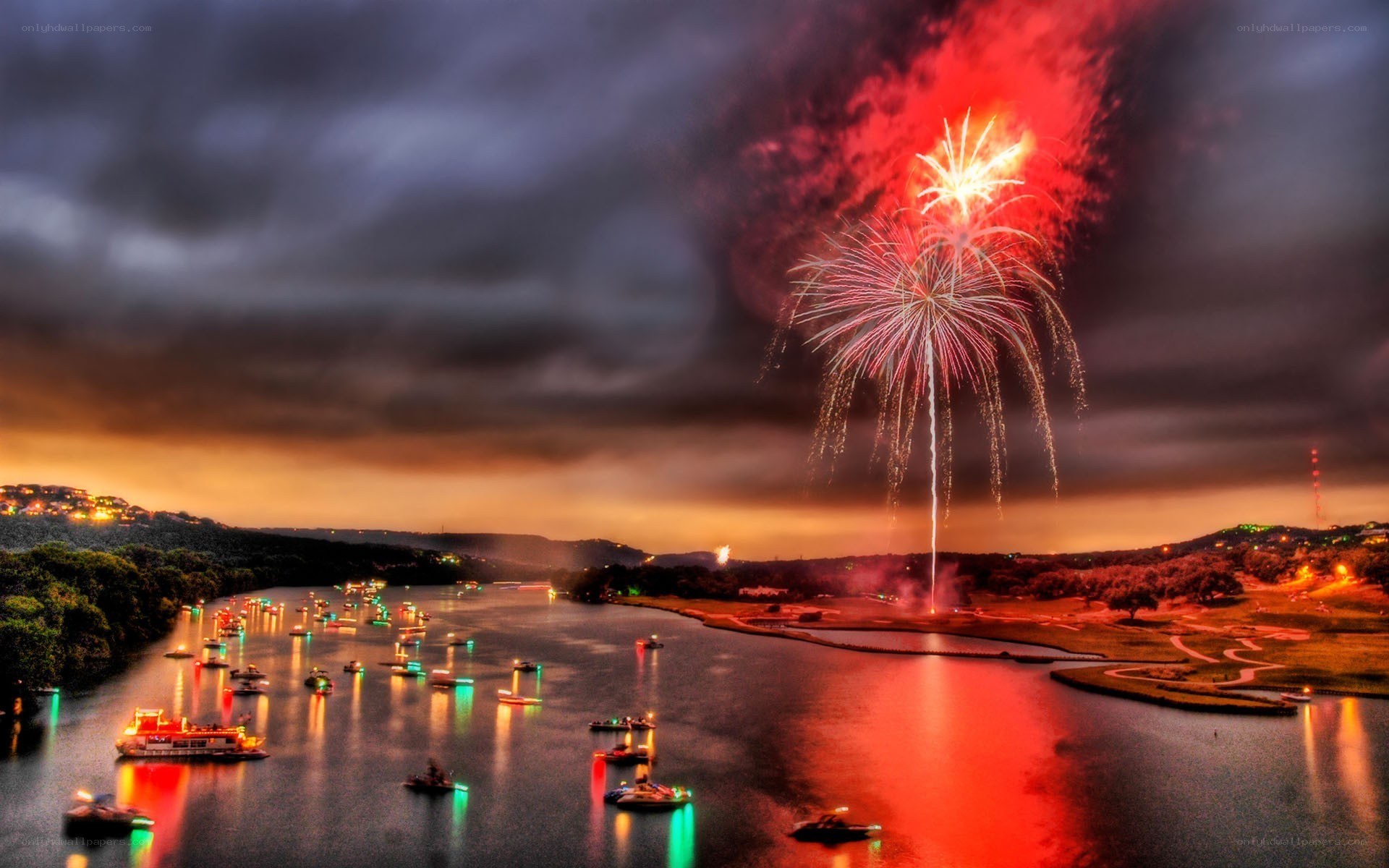 Fireworks over a lake at dusk