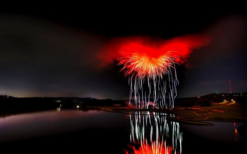 Fireworks over a lake at night