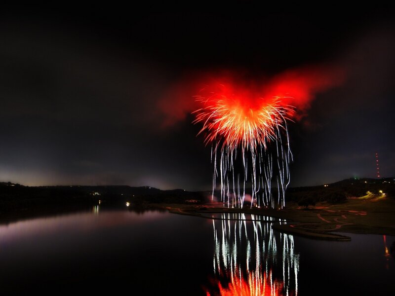 Fireworks over a lake at night