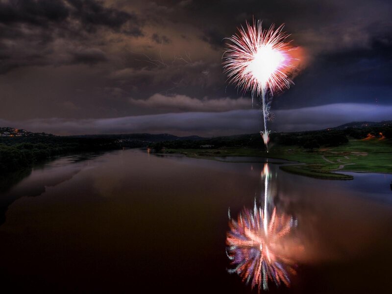 Fireworks over a lake at night