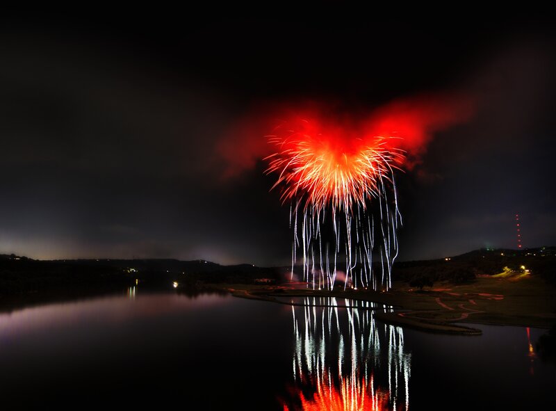 Fireworks over a lake at night