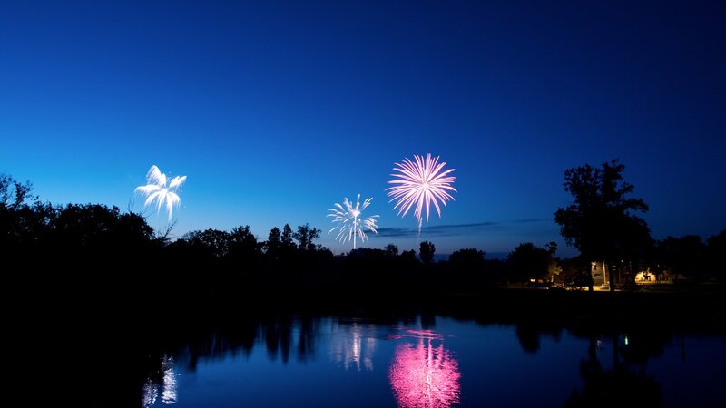 Fireworks over a lake at night