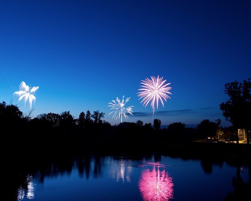 Fireworks over a lake at night