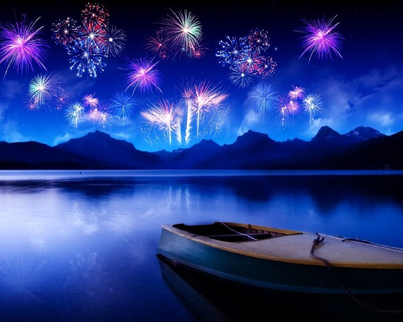 Fireworks over a lake at night