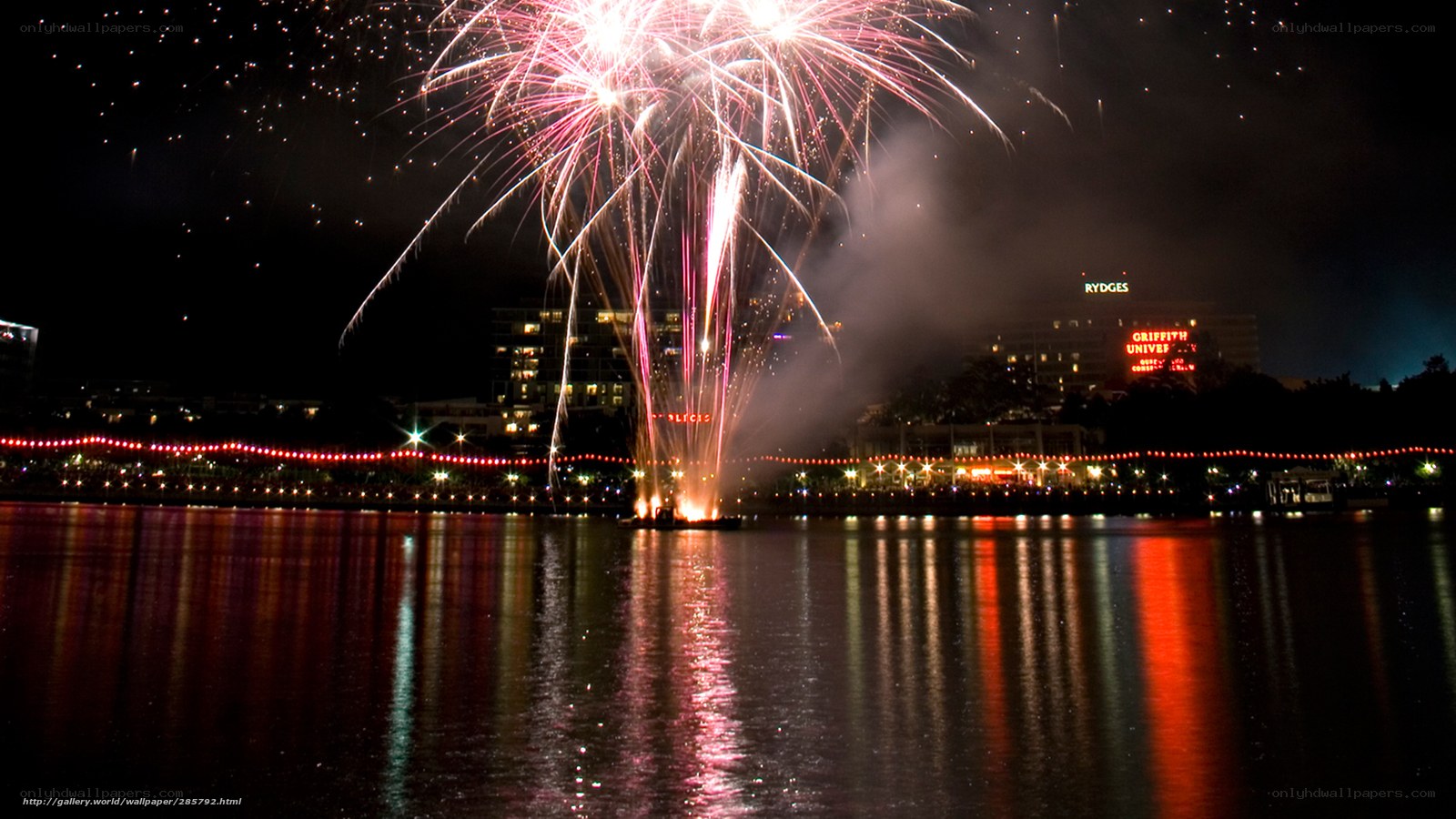 Fireworks over a lake at night
