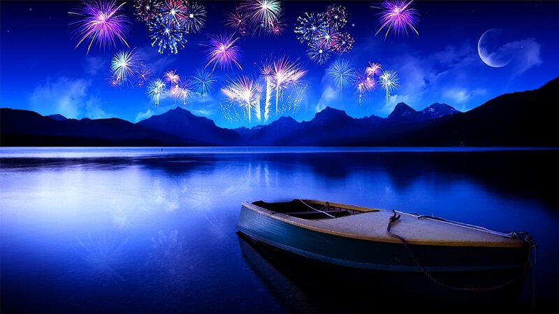 Fireworks over a lake at night