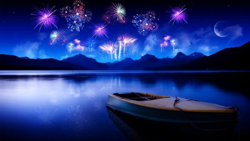 Fireworks over a lake at night